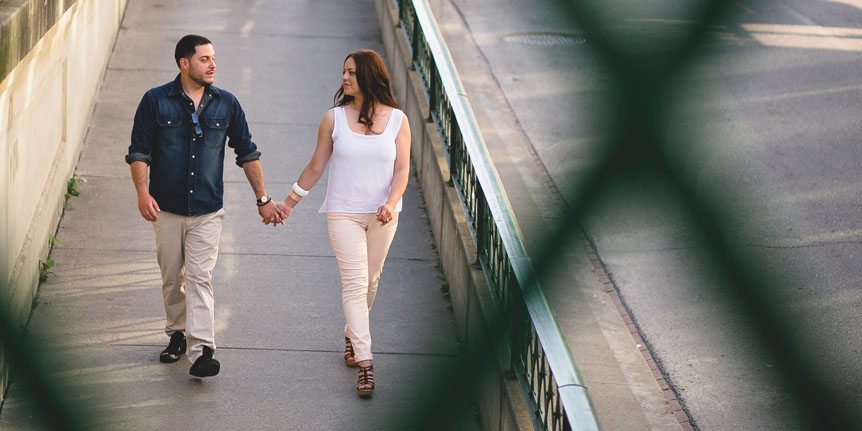 stylish couple walks down the street in Downtown Toronto during their engagement session with Toronto wedding photographer