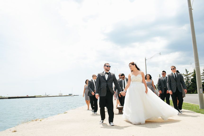 the newlyweds with their wedding party stroll around in Toronto's harbour