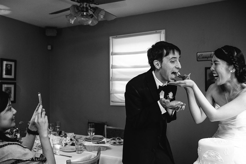a candid moment of the cake cutting as photographed by Mississauga wedding photographer.