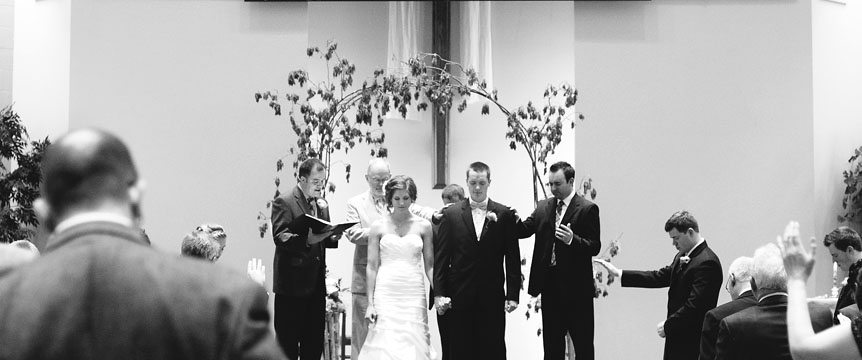 The bride and groom are blessed by their church members