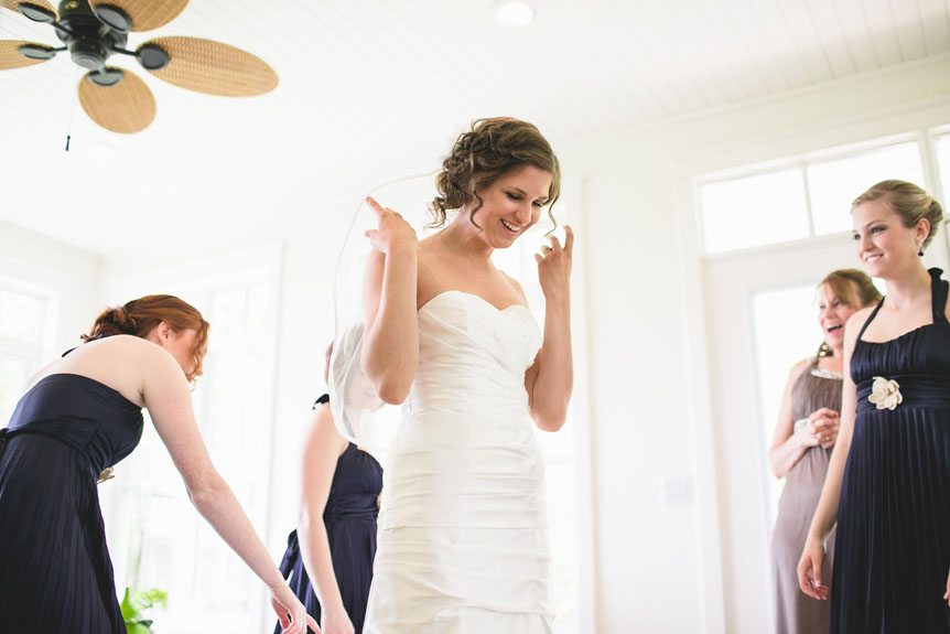 a beautiful moment as the bride gets her dress on and her family is in awe