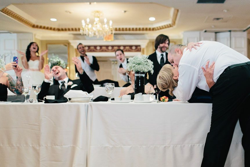 a funny and memorable moment at  Queen's Landing Hotel weddomg by a fine art wedding photojournalist