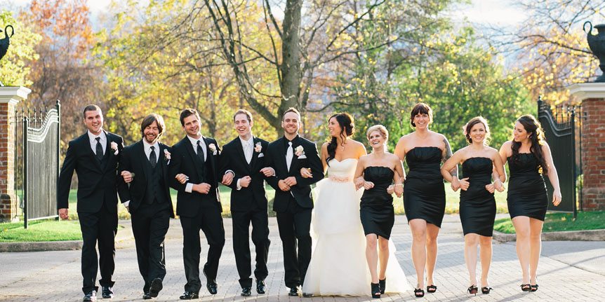 a beautiful portrait of the bride and groom and their wedding party by fine art wedding photographer