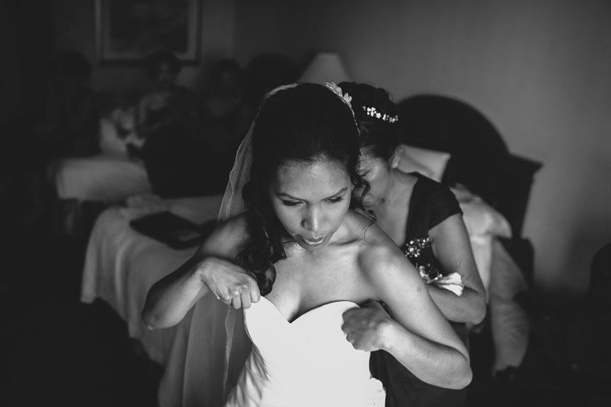 the bride puts on her gown as photographed by Toronto documentary wedding photographer