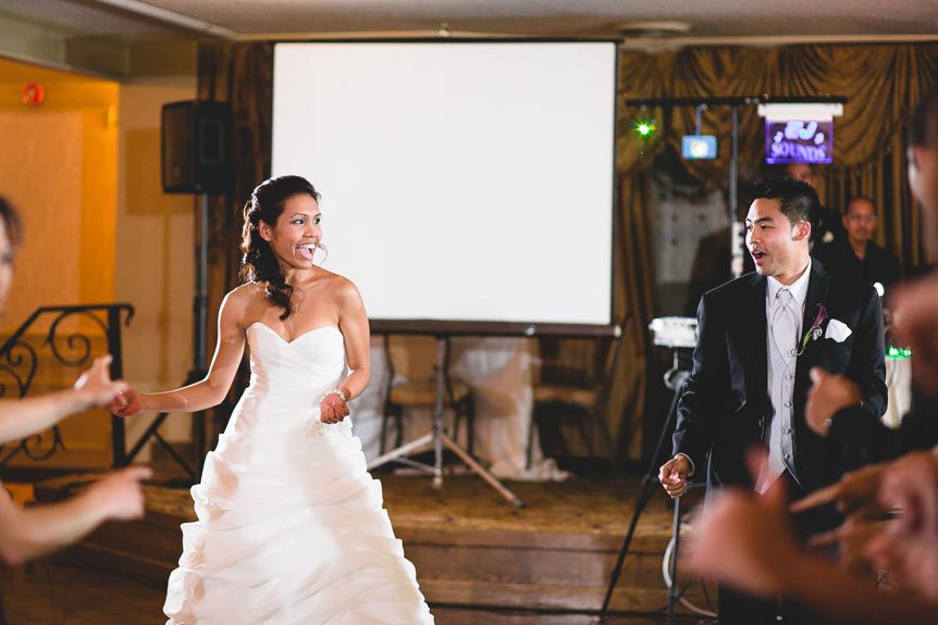 Toronto documentary wedding photographer captures the bride and groom as they entered their Liuna Gardens wedding reception