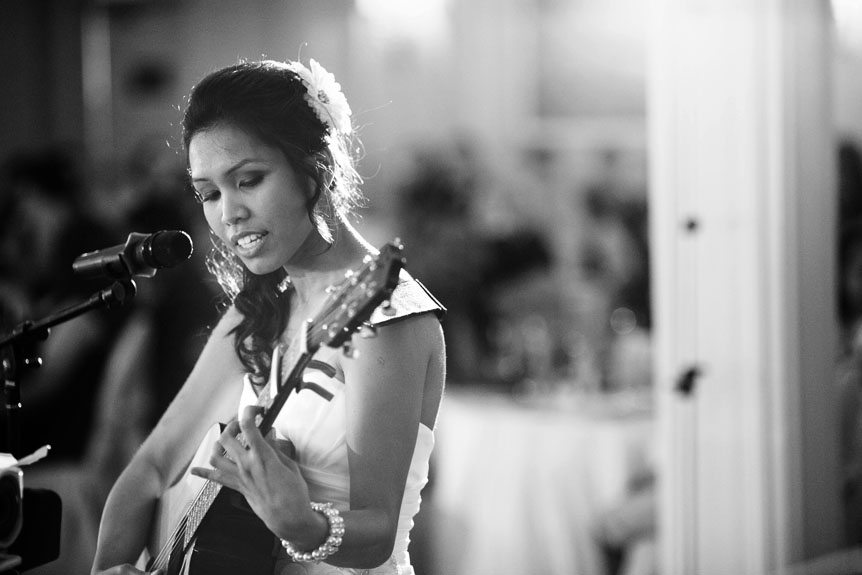 a bride sings a ballad at a Liuna Gardens wedding reception as photographed by Toronto documentary wedding photographer.
