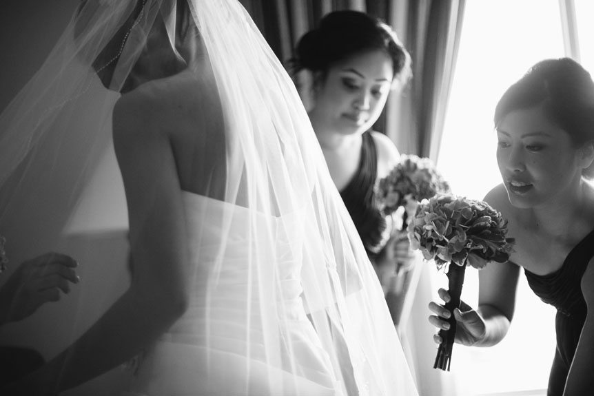 Toronto documentary wedding photographer captures the bridesmaids helping the bride