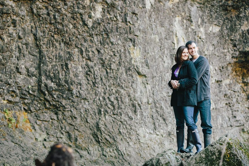 an engaged couple on a rock by Elora wedding photographer