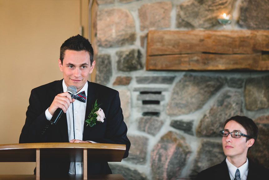 Newmarket Wedding Photographer captures the best man shares stories of the groom at a wedding reception at the Waterstone Estates and Farms.