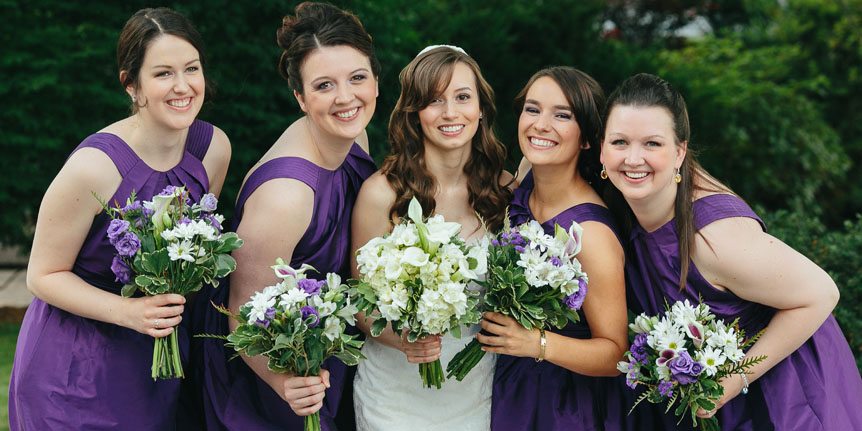 The bride and her bridesmaids all smile for a Cambridge Documentary Wedding Photographer.