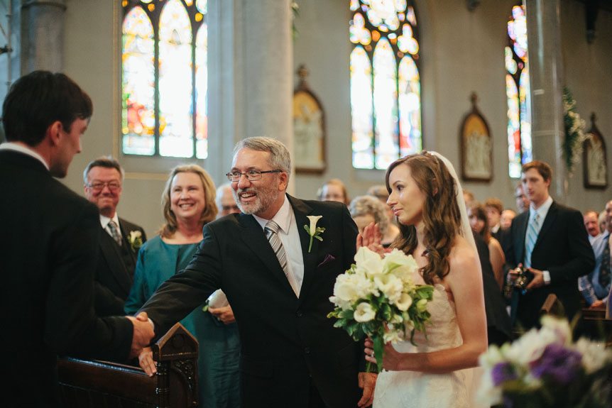 Cambridge Documentary Wedding Photographer captures the father of the bride shake the groom's hands as he gives his daughter away in marriage.