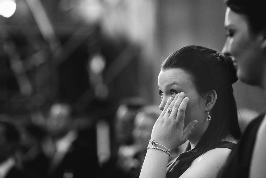 Cambridge Documentary Wedding Photographer captures the groom's sister as she shed a tear on her brother's wedding at the Church of Our Lady Immaculate.