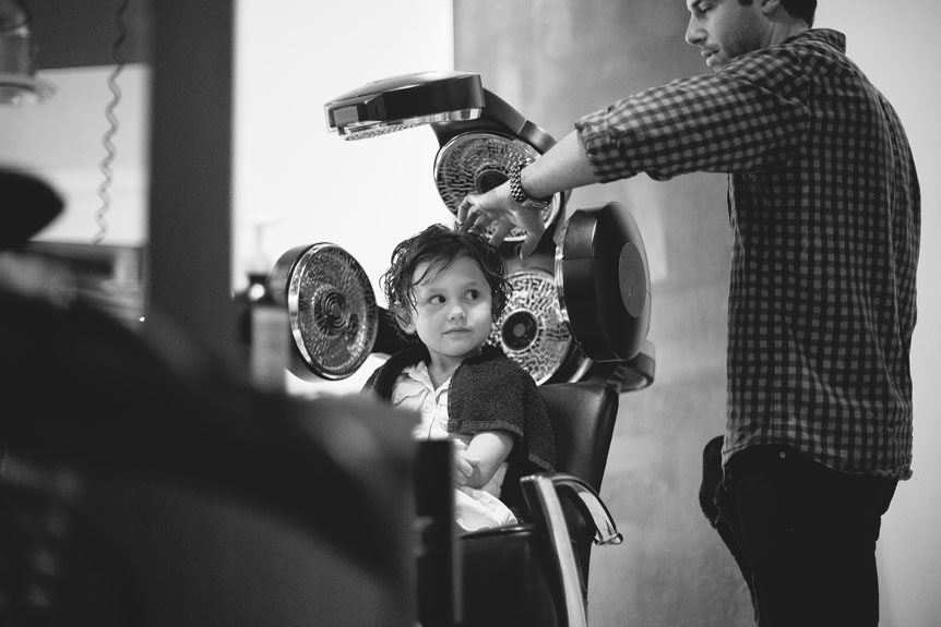 Cambridge Documentary Wedding Photographer photographs a cute girl getting her hair done at the Fusion Hair Studio