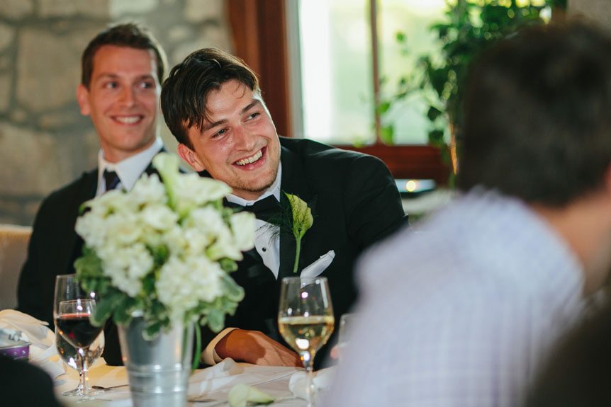 The groom reacting to his mother's speech at a Cambridge Mill wedding by Cambridge Documentary Wedding Photographer.