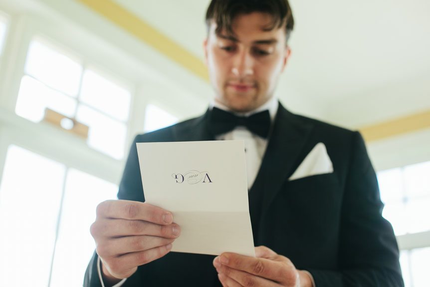 Cambridge Documentary Wedding Photographer shows the story of the groom reading a note from his bride the morning of their Cambridge Mill wedding.