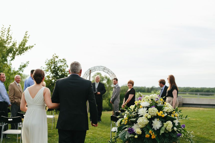The bride walks down the aisle at an intimate Flat Rocks Cellars wedding by Jordan, Ontario wedding photographer.