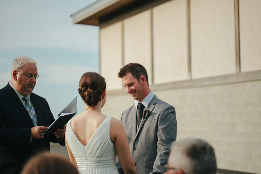 The groom listens to the bride's vows at their intimate wedding photographed by Jordan, Ontario wedding photographer.