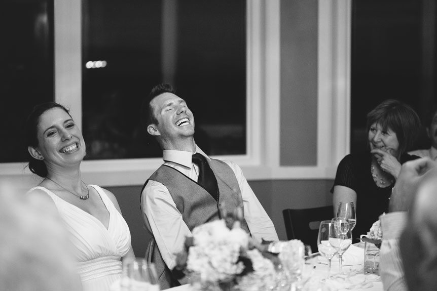 The bride and groom reacts to the bride's father speech at their Flat Rocks Cellars wedding as documented by Jordan, Ontario wedding photographer.