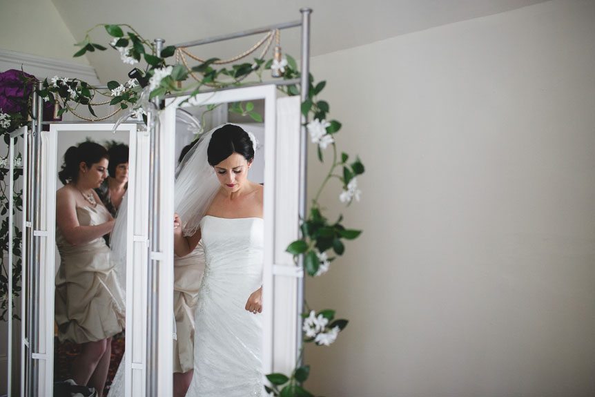 A candid moment photographed by Documentary Style Wedding Photography studio as the bride gets ready.