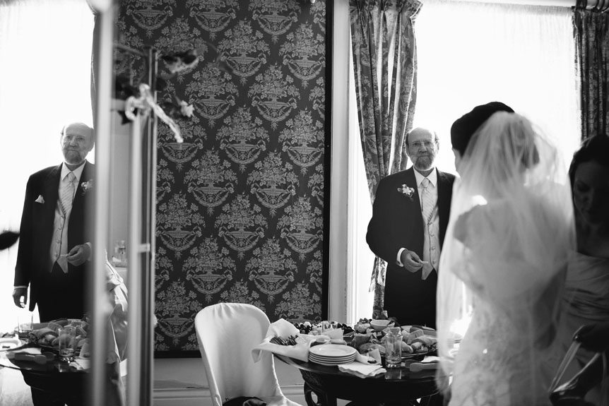 Father of the bride watched as his daughter became a bride as photographed by Documentary Style Wedding Photography studio.