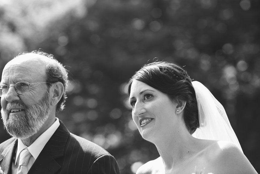 Documentary Style Wedding Photography studio photographs the bride and her father walk down the aisle at her Penryn Mansion wedding.