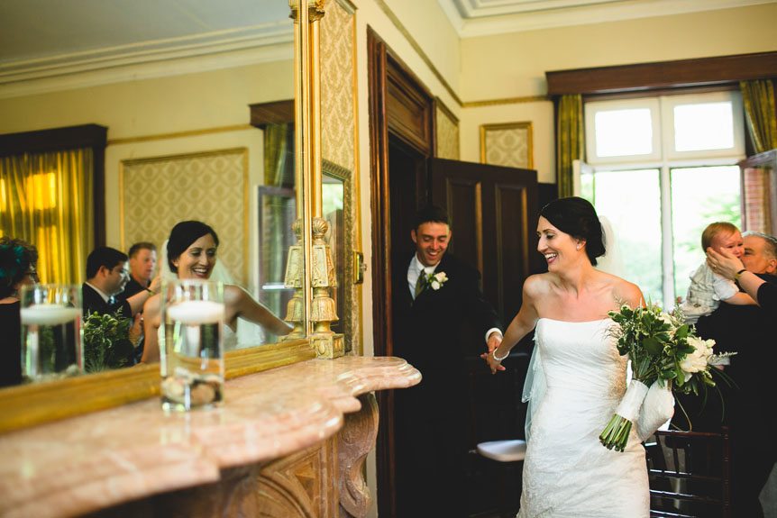 Documentary Style Wedding Photography studio captures the bride and groom enter the dining hall to join their guests at the Penryn Mansion.