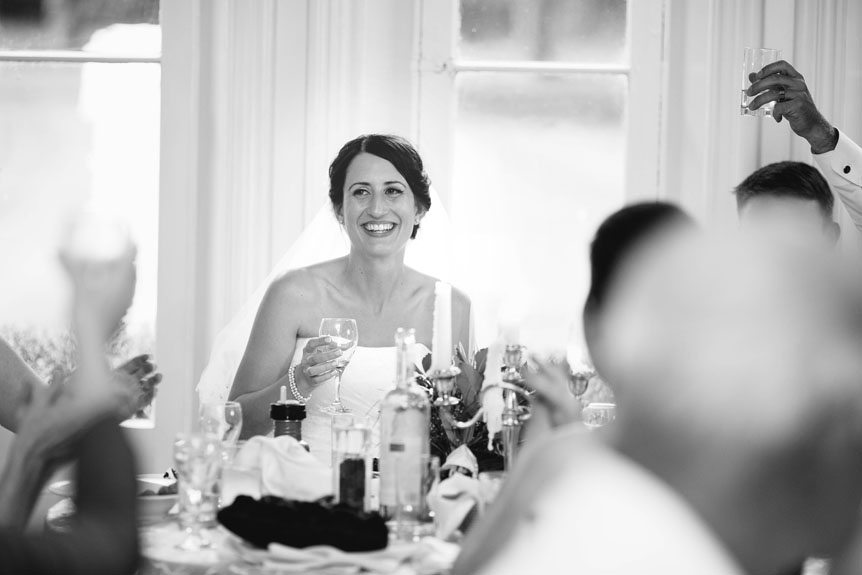The bride reacts to the speech at their Penryn Mansion wedding as photographed by Documentary Style Wedding Photography studio.