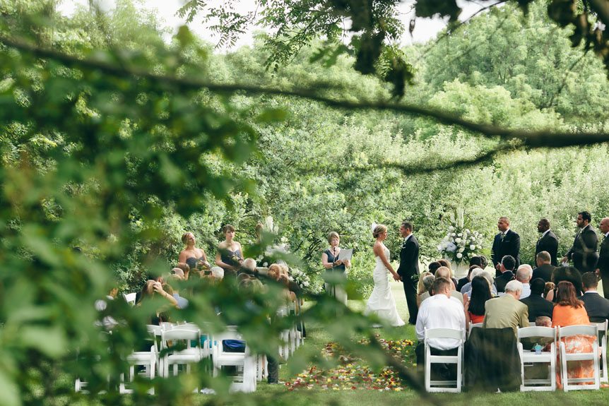 An outdoor wedding ceremony in Langdon Hall by Toronto wedding photographer.