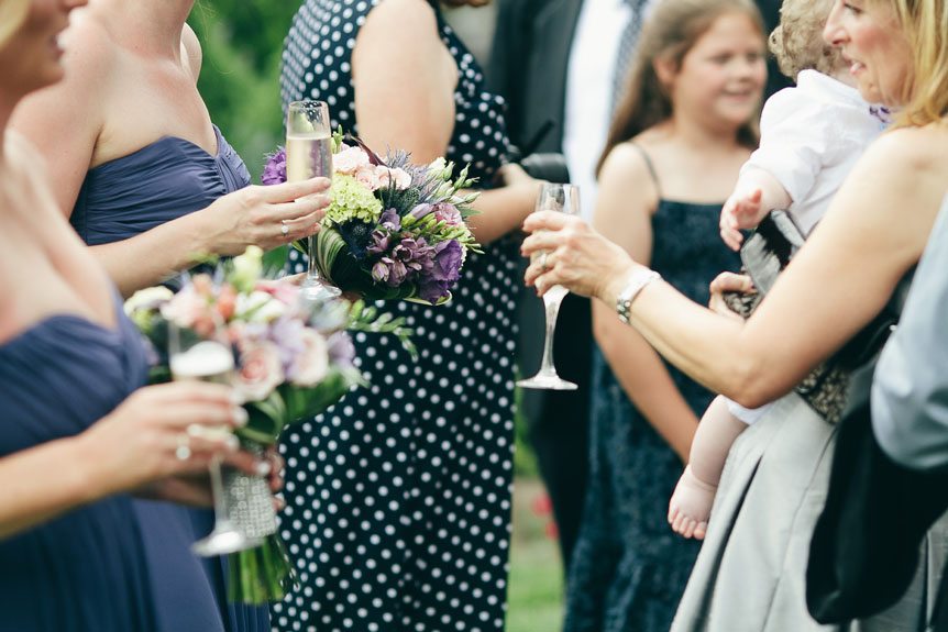 Guests mingle with the bridesmaids at a Langdon Hall wedding as photographed by Toronto wedding photographer.
