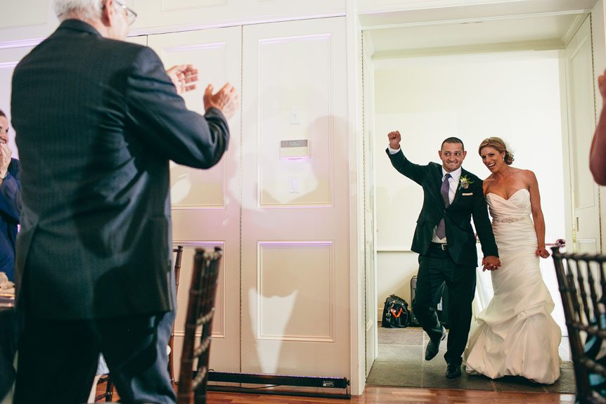 The bride and groom makes an entrance as photographed by Toronto wedding photographer in Langdon Hall.
