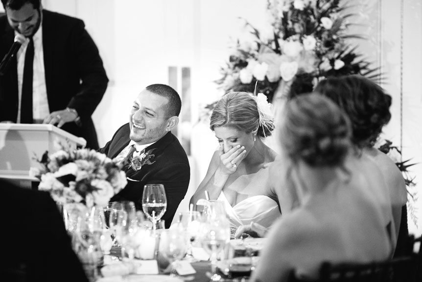 The bride and groom reacts to a funny speech at their Langdon Hall wedding as photographed by Toronto wedding photographer.