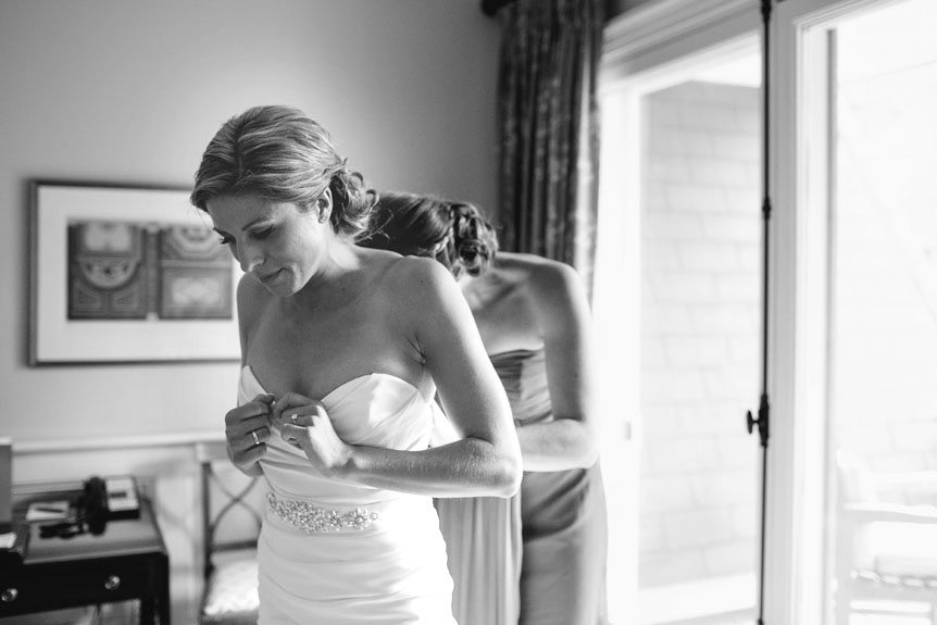 The bride inside the Langdon Hall bridal suite gets her gown on as photographed by Toronto wedding photographer.