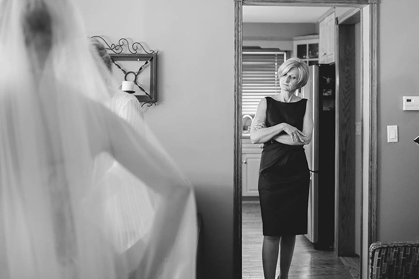 The mother of the bride has an emotional moment seeing her daughter before her wedding ceremony photographed by Cambridge Documentary Wedding Photographer.