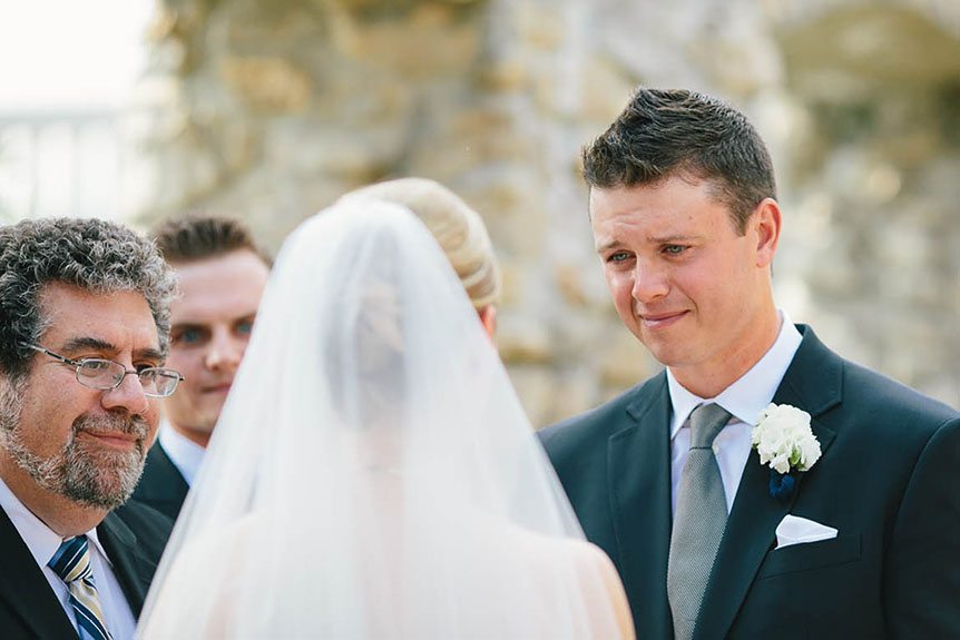 The groom is overwhelmed by emotions during the wedding ceremony as photographed by Cambridge Documentary Wedding Photographer.