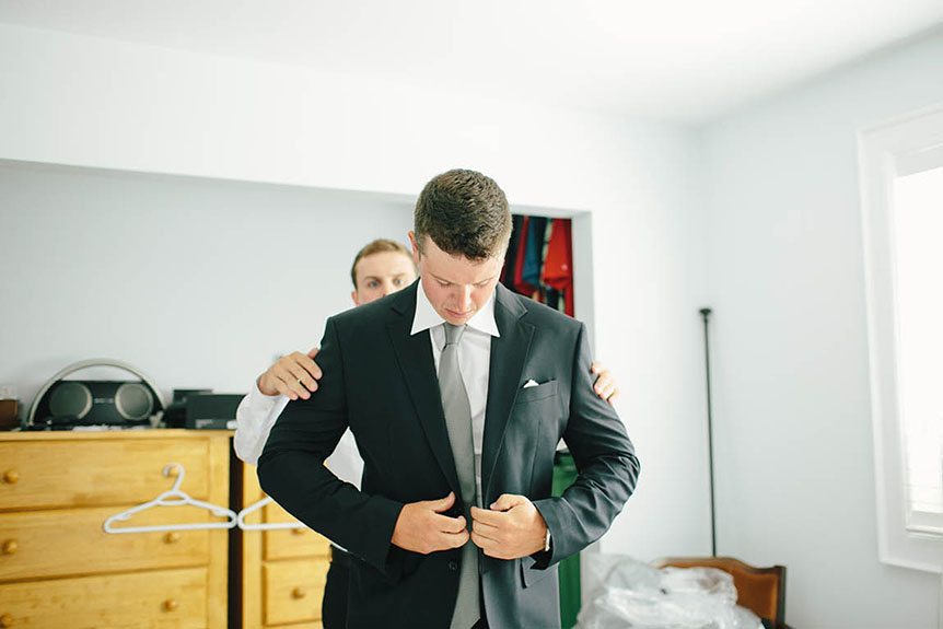 The groom gets ready and photographed before the wedding ceremony.