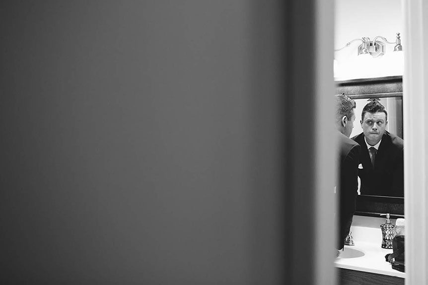 A candid moment captured by Cambridge Documentary Wedding Photographer while he gets ready before the wedding ceremony.