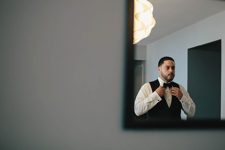 Toronto documentary wedding photographer photographs a groom as he gets ready before his Toronto wedding.