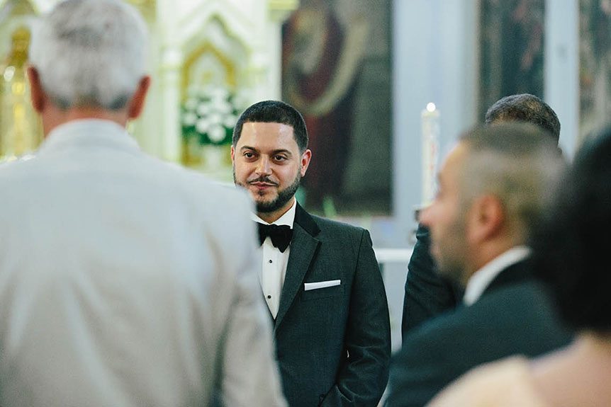 The groom gets to see his bride walk down the aisle as photographed by Toronto documentary wedding photographer.