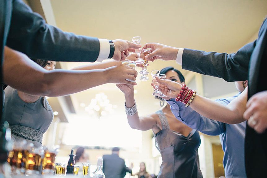 The wedding party toasts for the bride and groom as photographed by Toronto documentary wedding photographer.