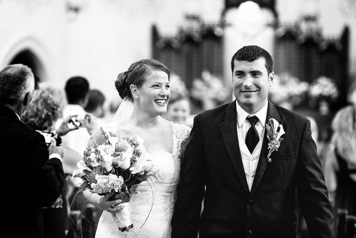 Wedding photojournalist captured the bride and groom as they walked down the aisle as newlyweds.