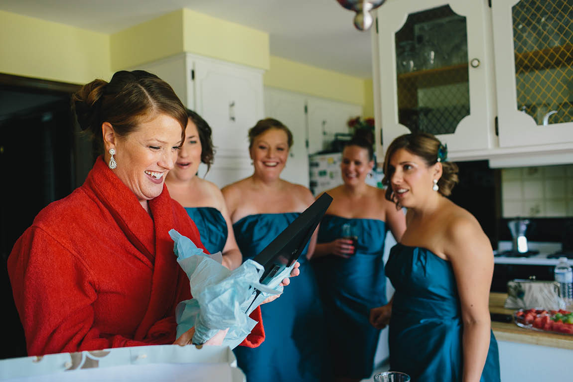 A candid moment of the bride with her bridesmaids the morning of her wedding.