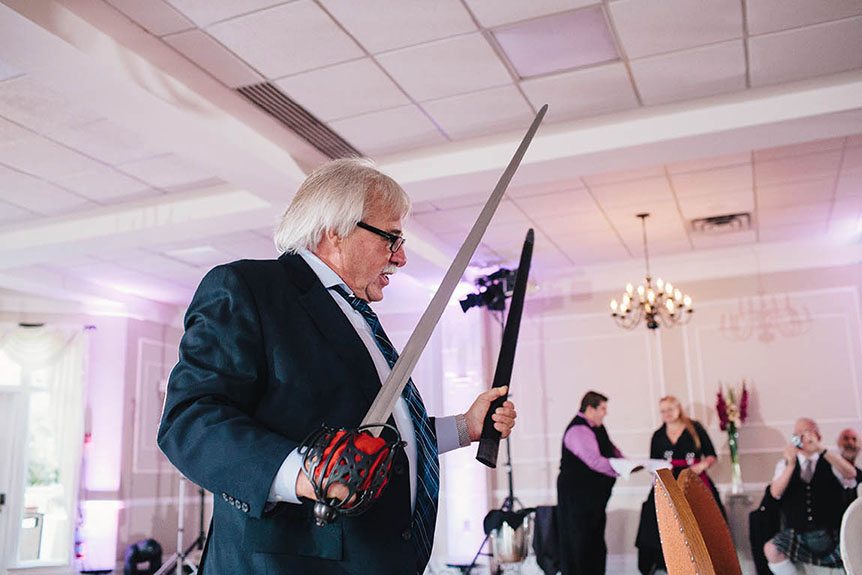 A man with a sword at an Elm Hurst Inn wedding.