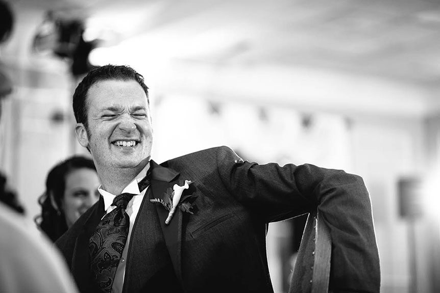 The groom reacts to his best man's speech at an Elm Hurst Inn wedding.