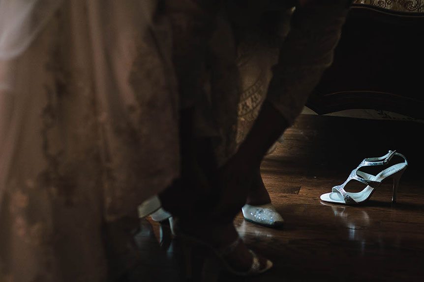 A detail shot of the bride's shoes captured by a fine art wedding photographer.