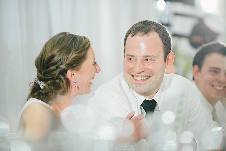 The bride and groom react to their parents' speech at their Three Bridges Banquet Hall wedding.