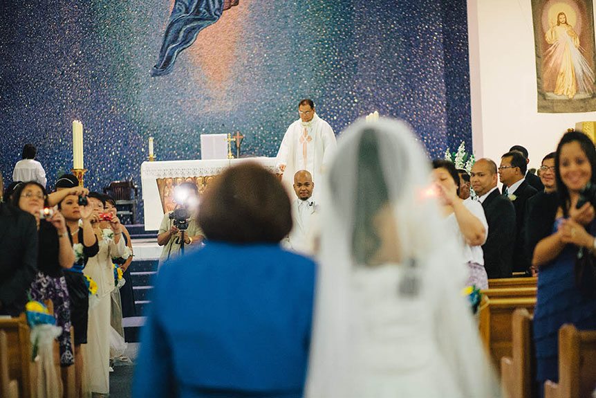 Filipino wedding photographer captures the groom's reaction as he sees his bride walk down the aisle.