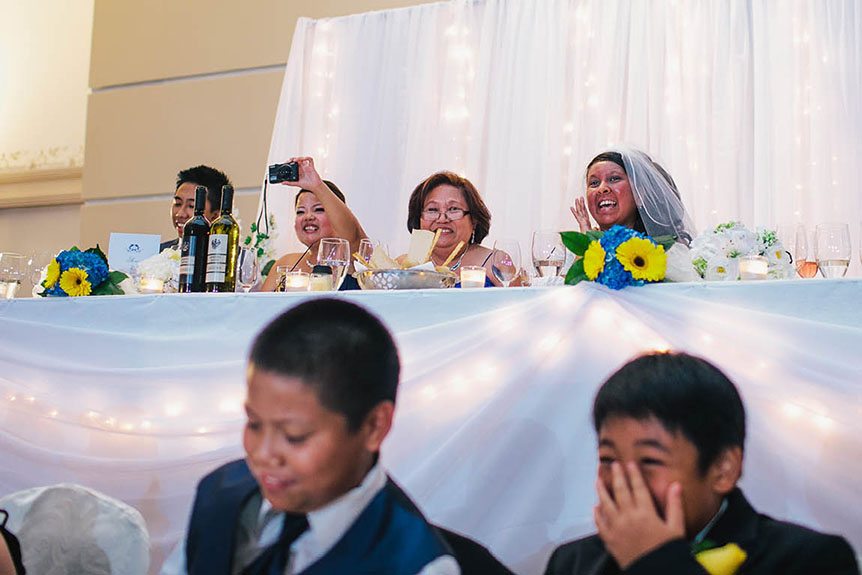 The bride reacts to the groom's surprise number.