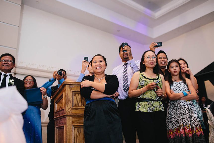 The guests reacts to a funny moment at a Filipino wedding reception at the Grand Baccus Banquet and Conference Center.