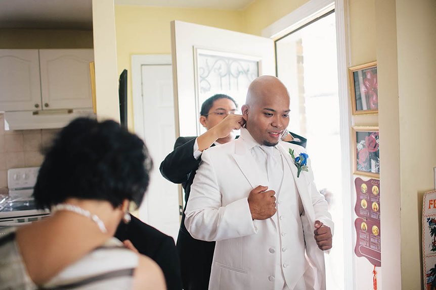 A Filipino family gets ready before the groom's wedding ceremony.
