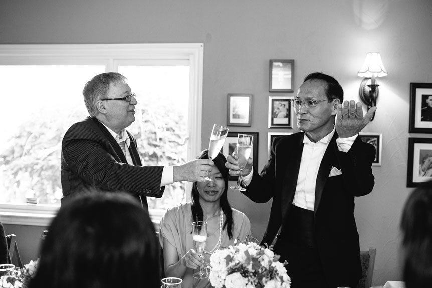 The fathers of the bride and groom toast to the newlyweds at an intimate Port Credit wedding.